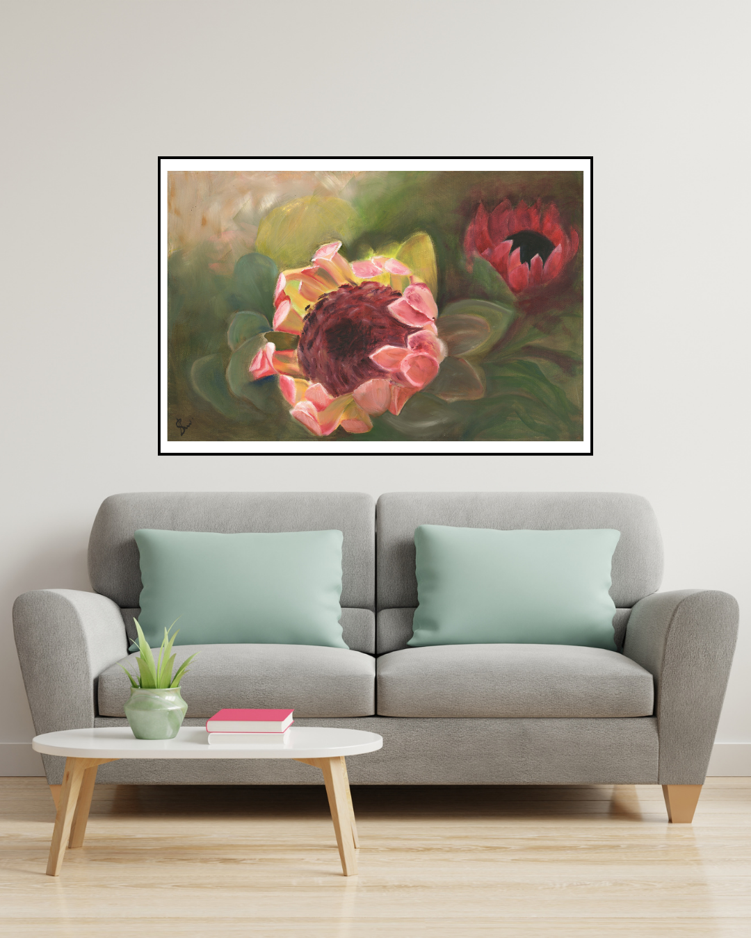 Limited edition print of ‘Cape Beauty’ by Stephreen Mapstone displayed above a grey couch with pale green cushions. The protea artwork brings warmth and organic softness, complementing the muted tones with a touch of natural charm.