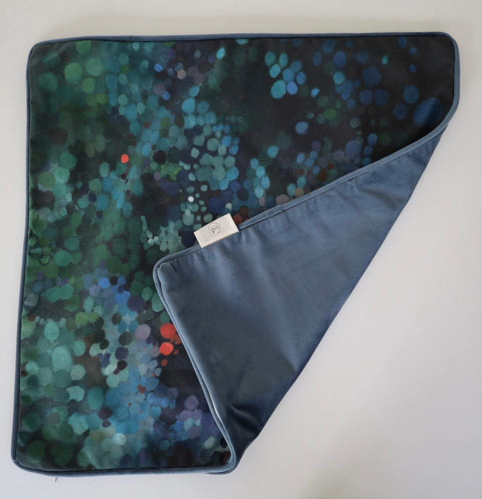 Image shows folded back and front of square 60×60 cm cushion cover with abstract green and blue oil painting print, velvet piping, velvet back, and concealed zip closure.