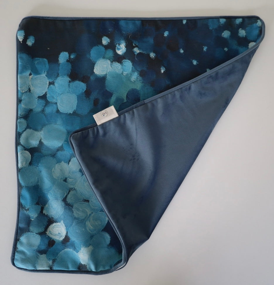 Image shows folded back and front of square 60×60 cm cushion cover with abstract blues oil painting print, velvet piping, velvet back, and concealed zip closure.